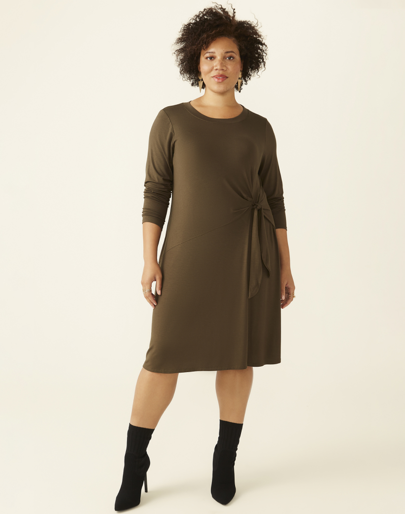 plus size woman in long sleeve olive colored mini dress and black boots